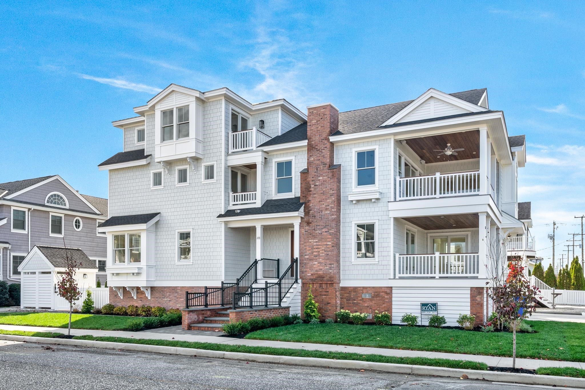 188 34th Street Avalon, NJ 08202 - Photo 1 of 47 a front view of a residential apartment building with a yard