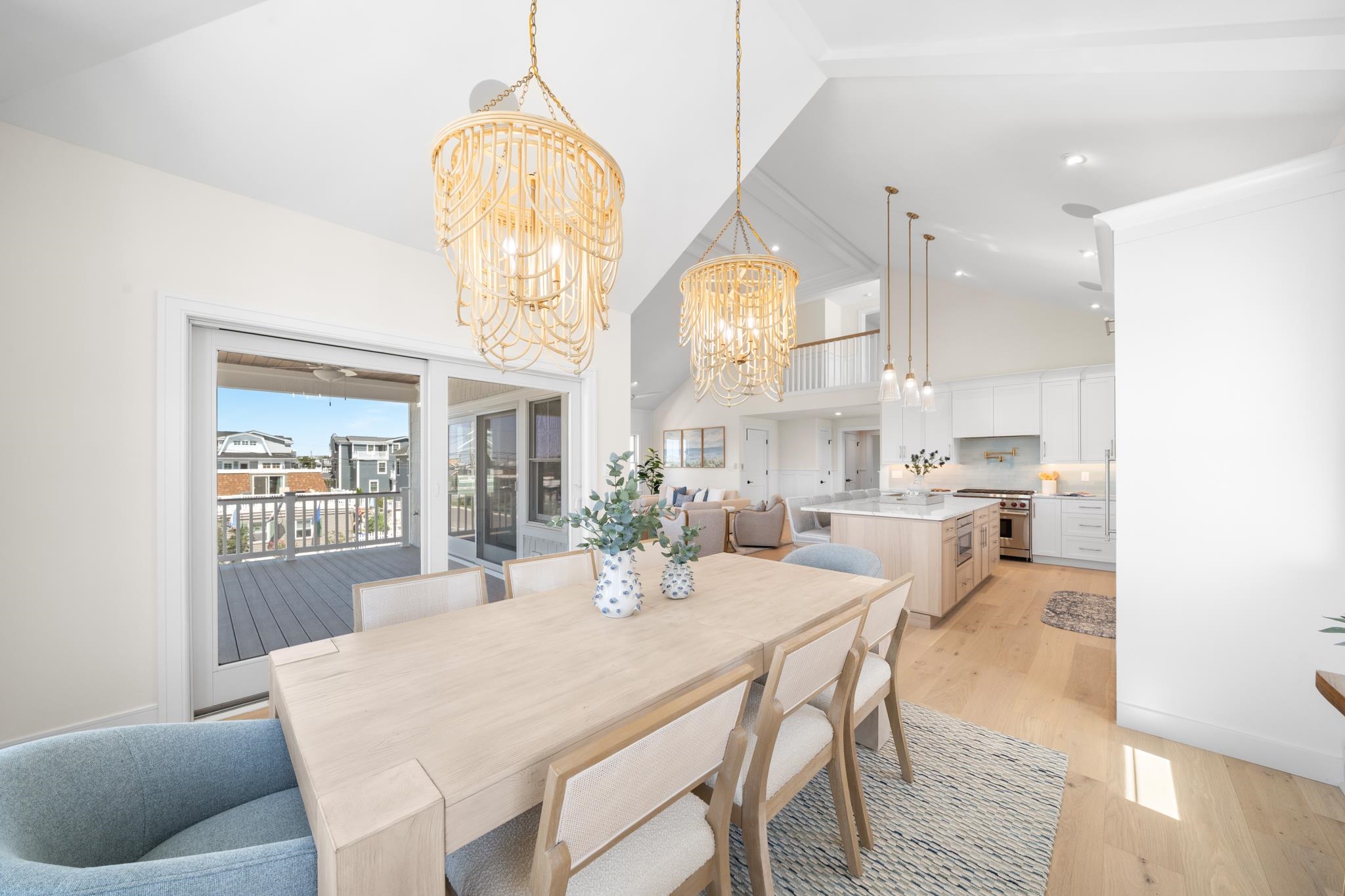 188 34th Street Avalon, NJ 08202 - Photo 21 of 47 a dining room with wooden floor a chandelier a wooden table and chairs