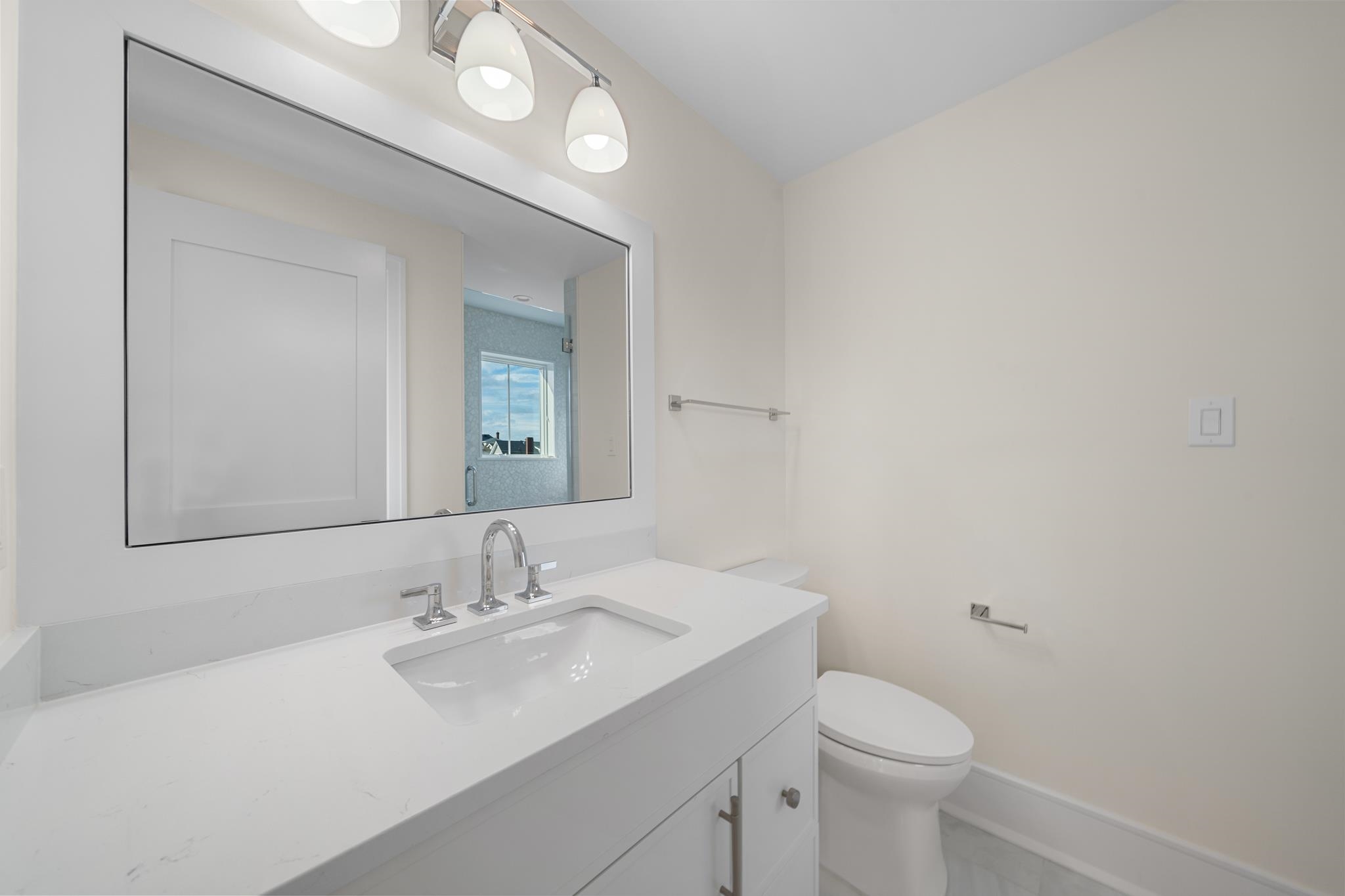 188 34th Street Avalon, NJ 08202 - Photo 37 of 47 a bathroom with a sink a toilet and a mirror