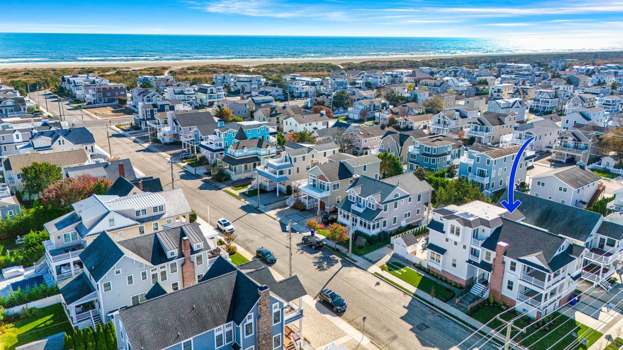 188 34th Street Avalon, NJ 08202 - Photo 5 of 47 an aerial view of a city with lots of residential buildings and ocean view in back