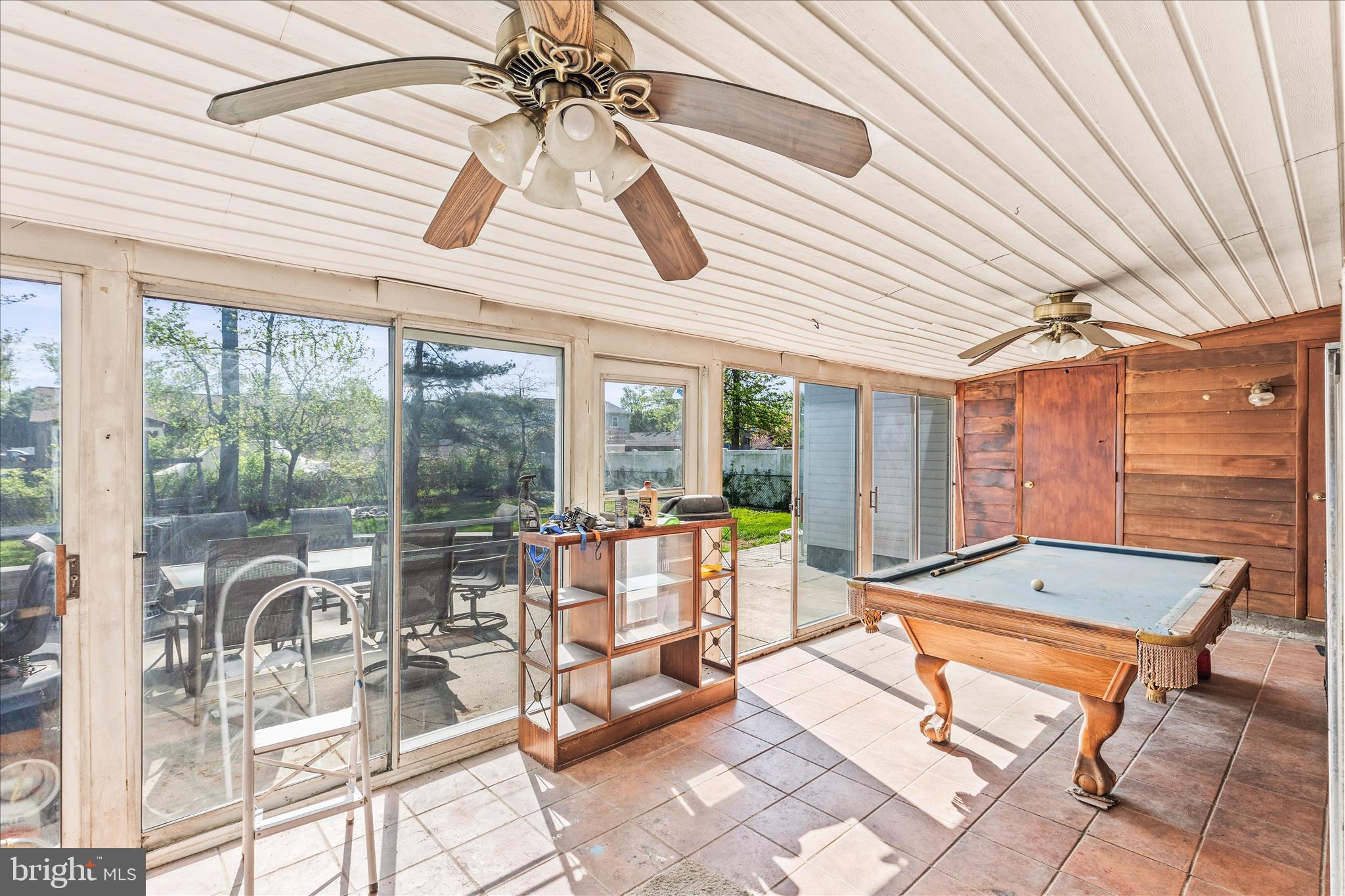 2219 Lodge Farm Road Sparrows Point, MD 21219 - Photo 28 of 36 a living room with patio furniture and floor to ceiling windows