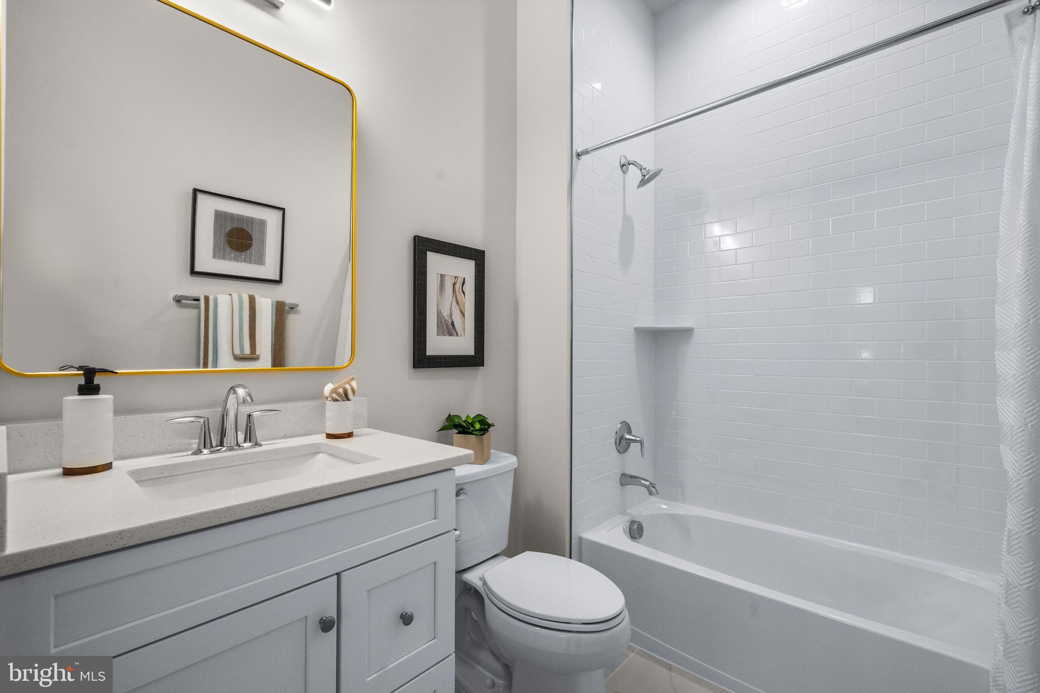 7505 Magarity Road Falls Church, VA 22043 - Photo 20 of 69 a bathroom with a toilet a sink a mirror a bathtub and shower