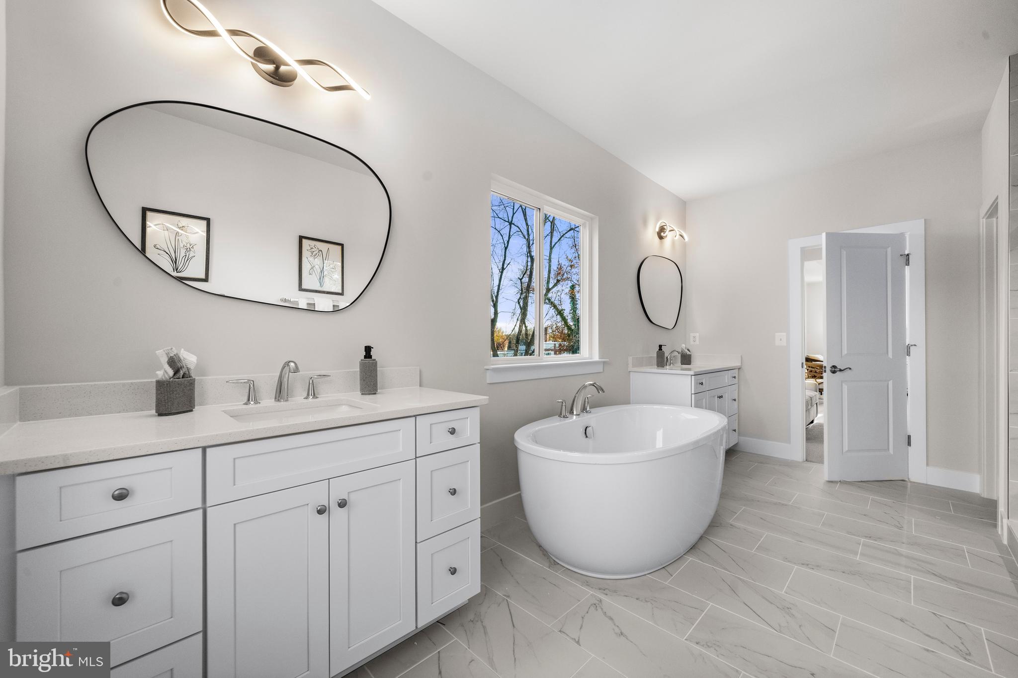 7505 Magarity Road Falls Church, VA 22043 - Photo 30 of 69 a bathroom with a sink and mirror with wooden floor