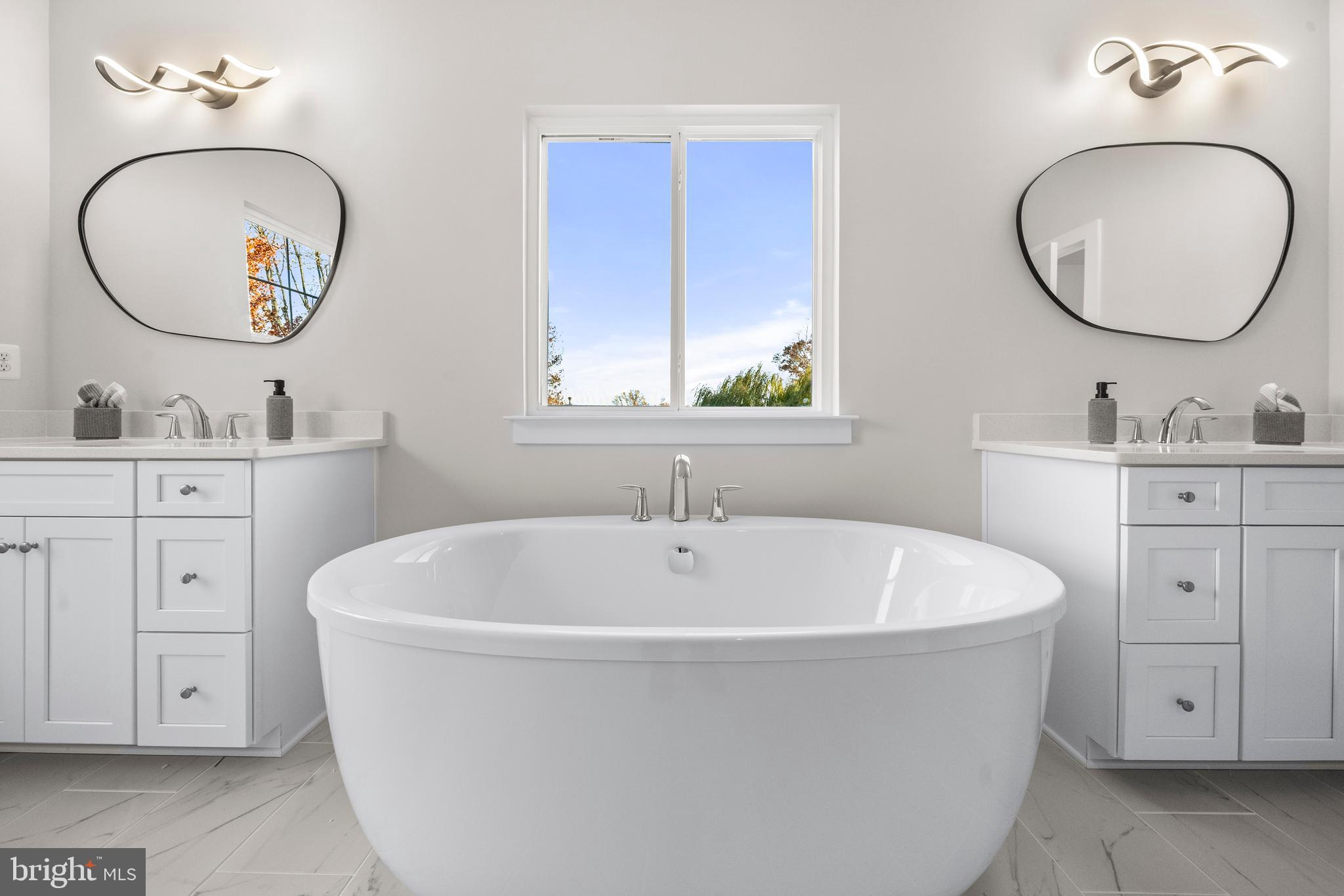 7505 Magarity Road Falls Church, VA 22043 - Photo 31 of 69 a white bath tub sitting next to a bathroom sink