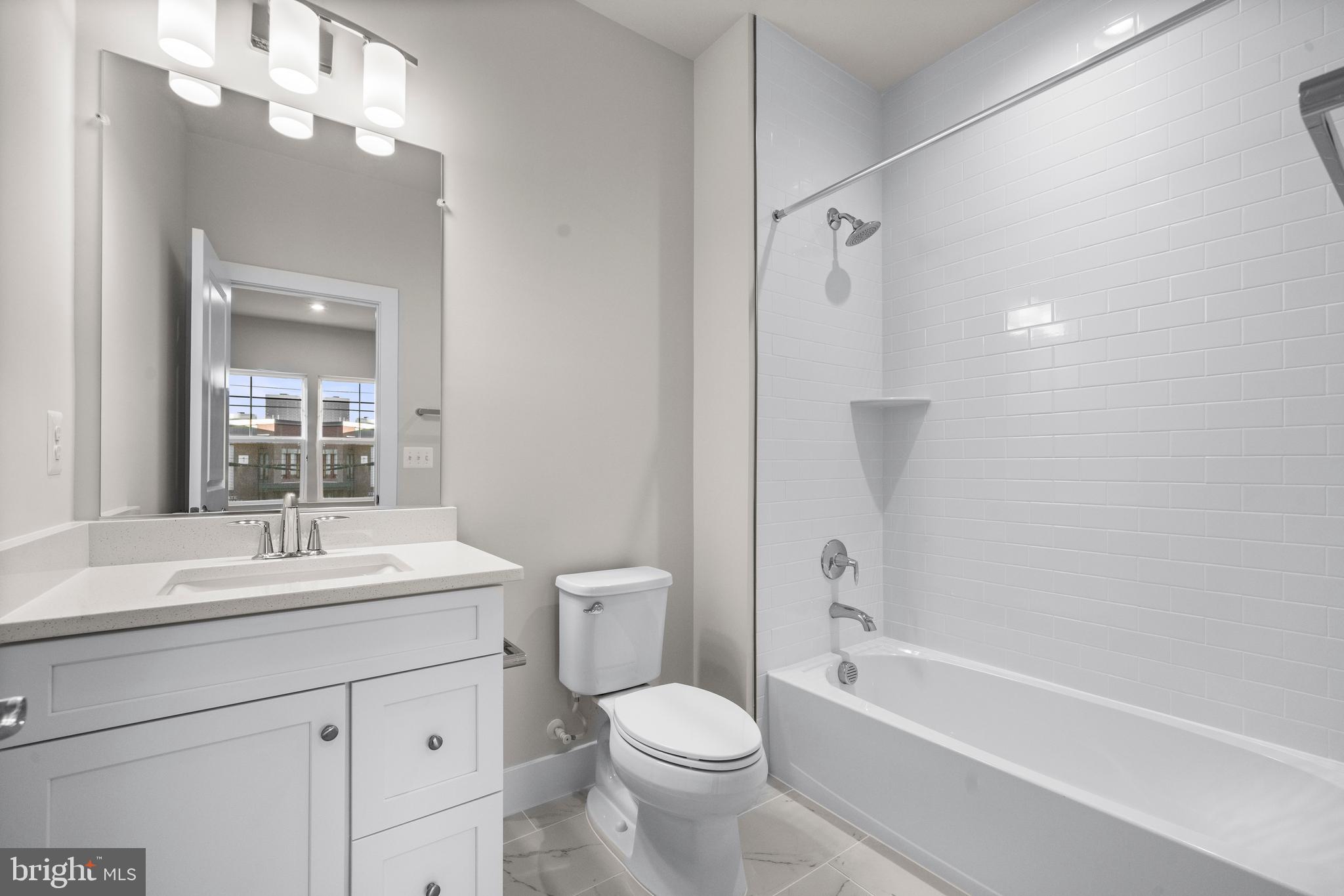 7505 Magarity Road Falls Church, VA 22043 - Photo 40 of 69 a bathroom with a sink a toilet and shower