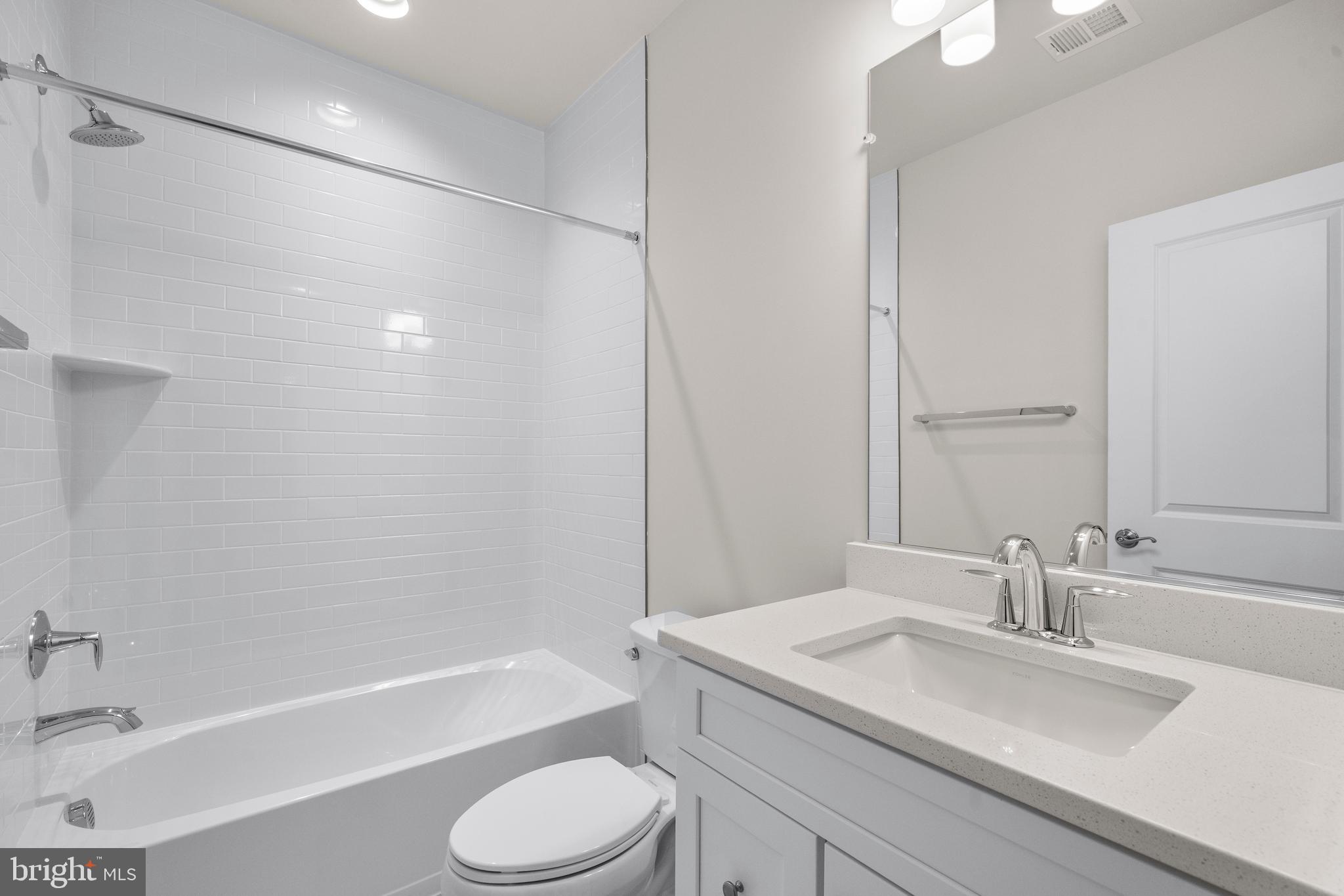 7505 Magarity Road Falls Church, VA 22043 - Photo 59 of 69 a bathroom with a granite countertop sink toilet and shower