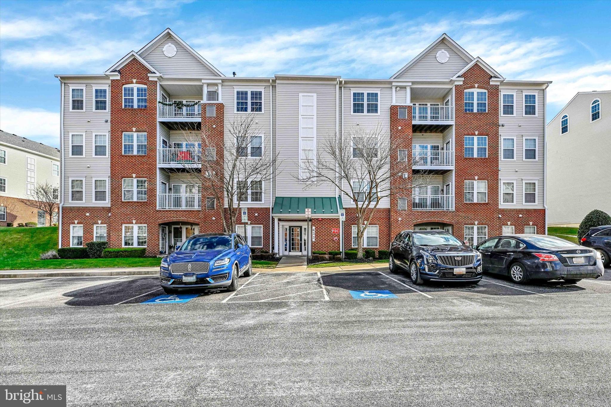 a car parked in front of a building and cars parked