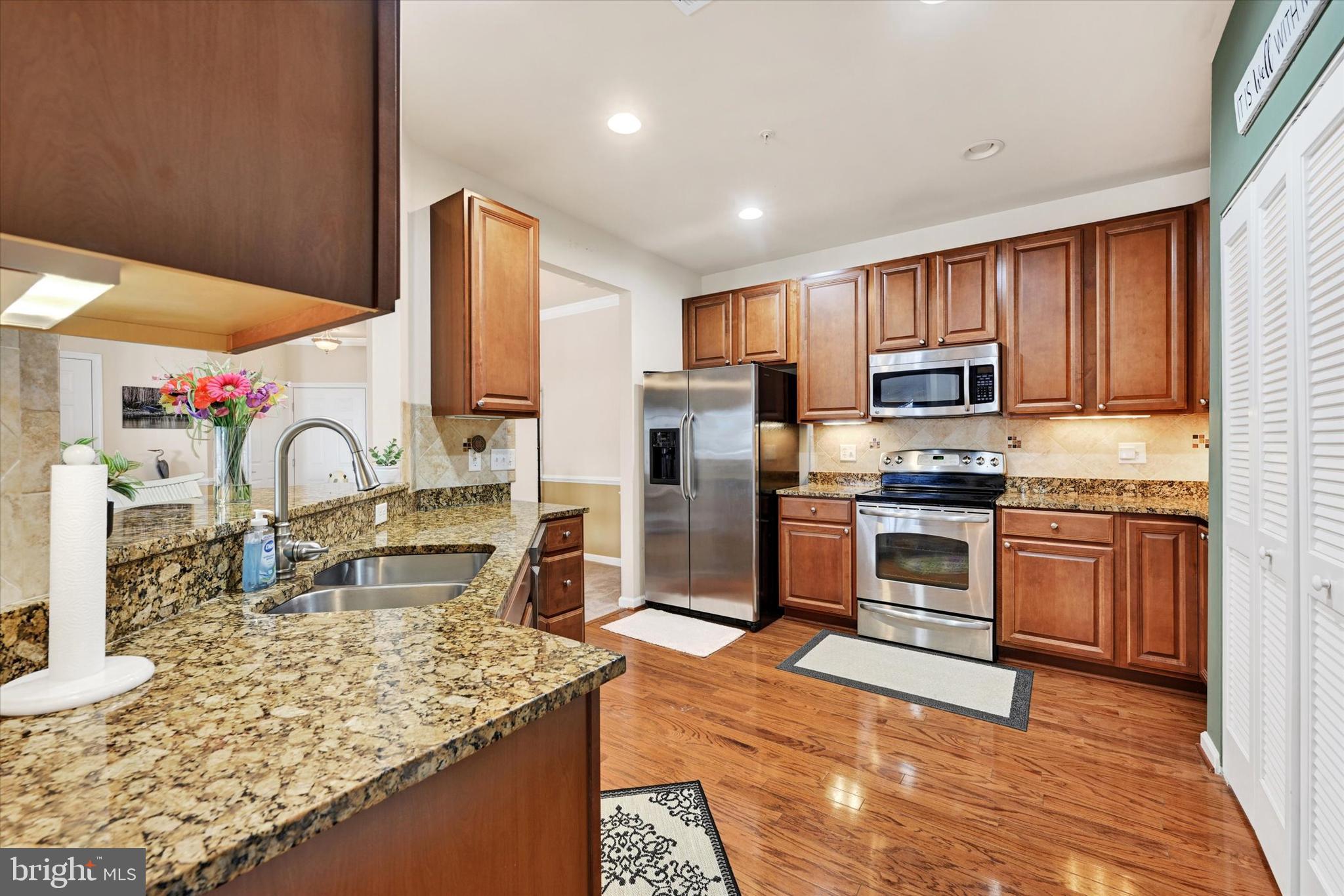 633 Wallingford Road, Unit 302 Bel Air, MD 21014 - Photo 10 of 26 a kitchen with kitchen island granite countertop a stove top oven a sink and dishwasher