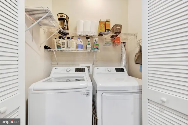 a kitchen with kitchen island granite countertop a stove top oven a sink and dishwasher