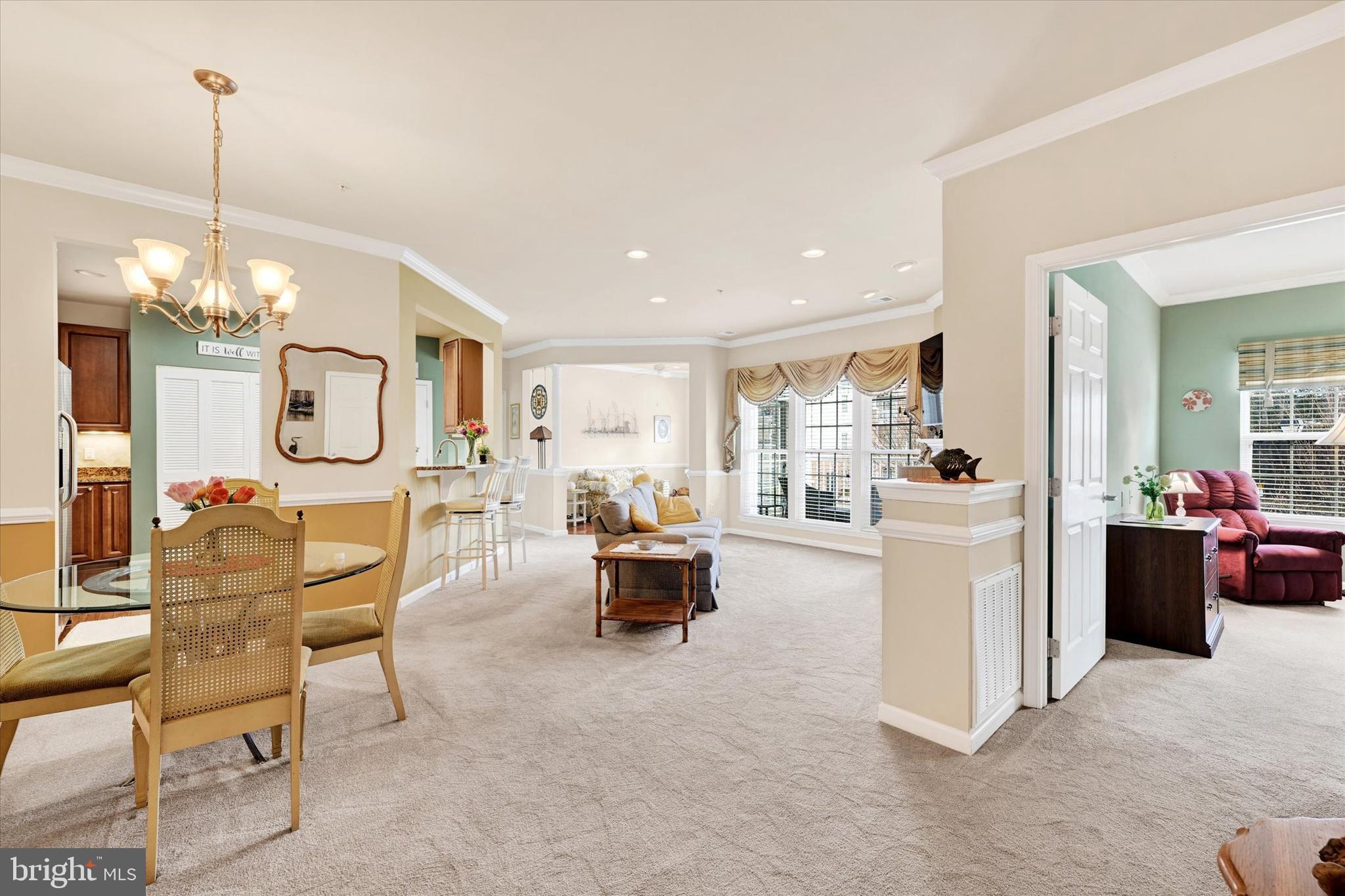 633 Wallingford Road, Unit 302 Bel Air, MD 21014 - Photo 3 of 26 a living room with furniture a chandelier and a view of kitchen