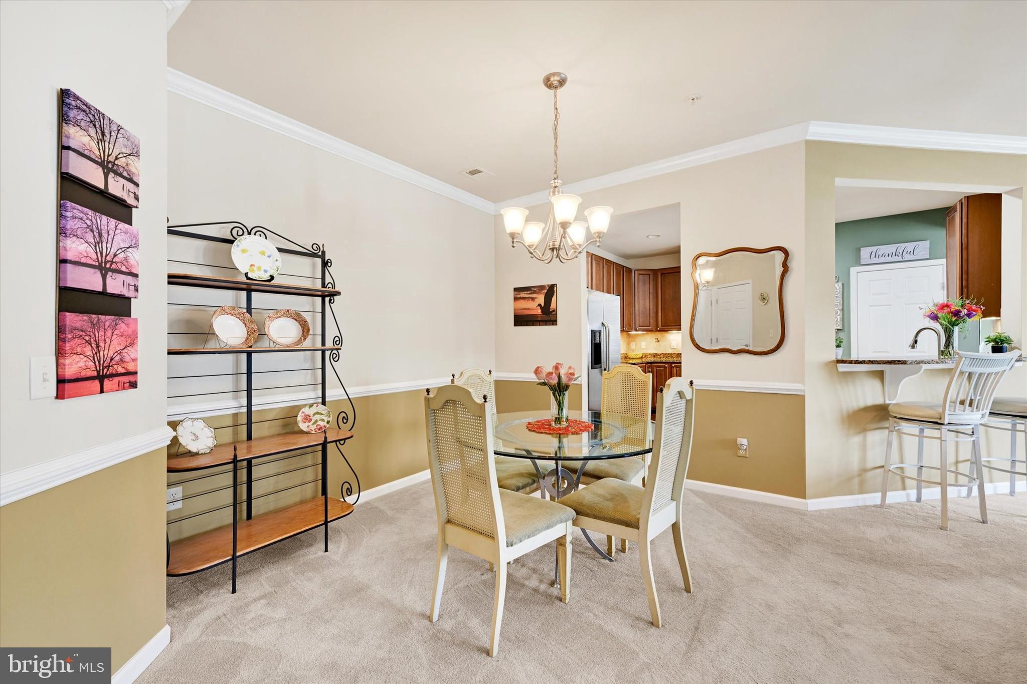 633 Wallingford Road, Unit 302 Bel Air, MD 21014 - Photo 5 of 26 a view of a dining room with furniture and chandelier