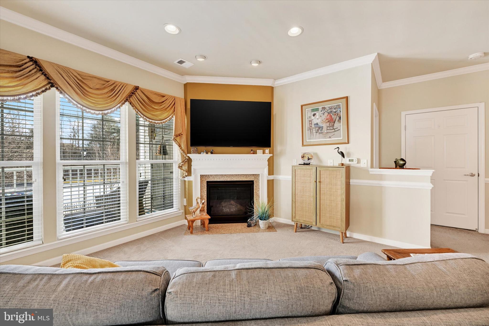 633 Wallingford Road, Unit 302 Bel Air, MD 21014 - Photo 6 of 26 a living room with furniture a fireplace and a flat screen tv