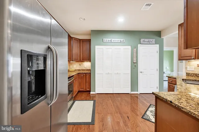a kitchen with stainless steel appliances granite countertop a stove and a sink