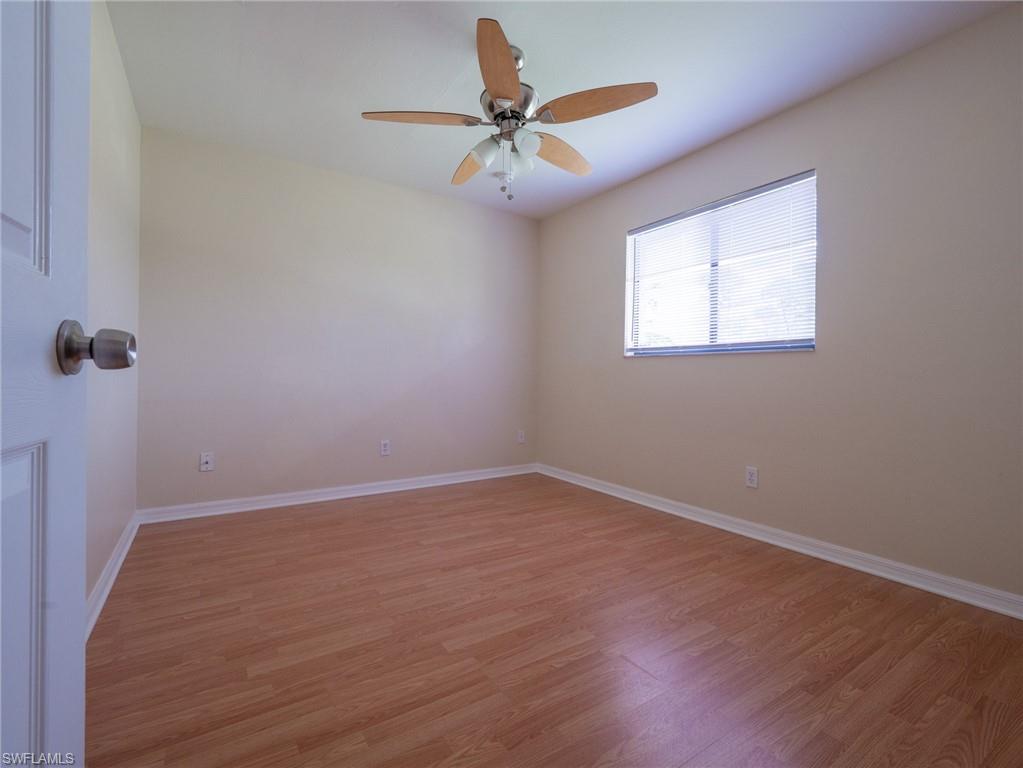 18414 Tulip Road Fort Myers, FL 33967 - Photo 23 of 37 Well-lit room featuring wood-finish flooring, a ceiling fan with light fixture, and a window with horizontal blinds