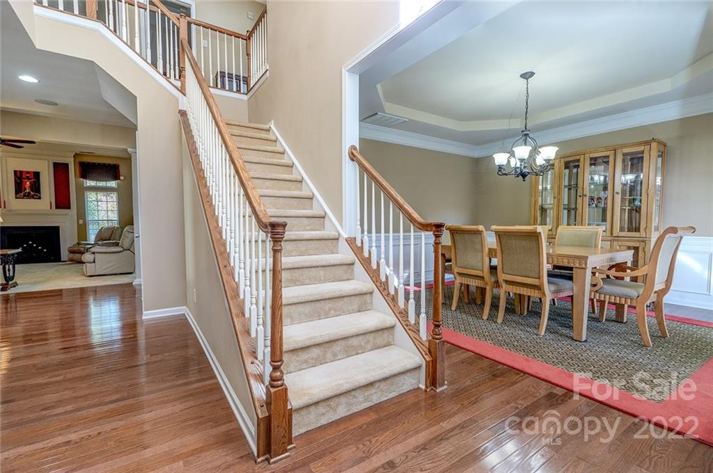 225 Fischer Road Fort Mill, SC 29715 - Photo 2 of 32 a view of a dining room with wooden floor windows and a chandelier
