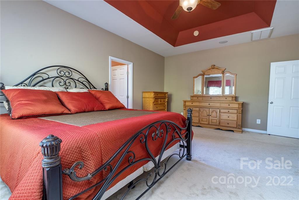 225 Fischer Road Fort Mill, SC 29715 - Photo 21 of 32 a bedroom with a bed and a painting on the wall