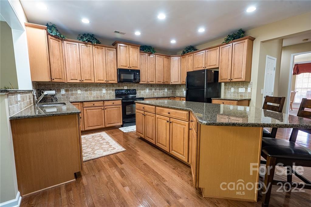 225 Fischer Road Fort Mill, SC 29715 - Photo 7 of 32 a kitchen with stainless steel appliances granite countertop refrigerator a stove top oven a sink and dishwasher