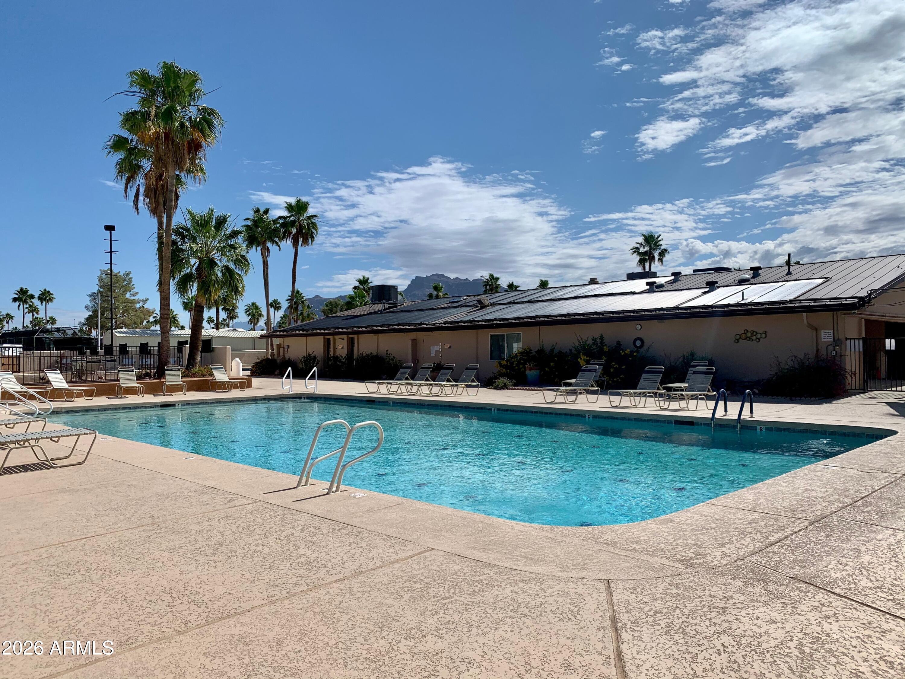 1024 Prospector Drive, Unit 1024 Apache Junction, AZ 85119 - Photo 10 of 40 a view of a swimming pool with a garden