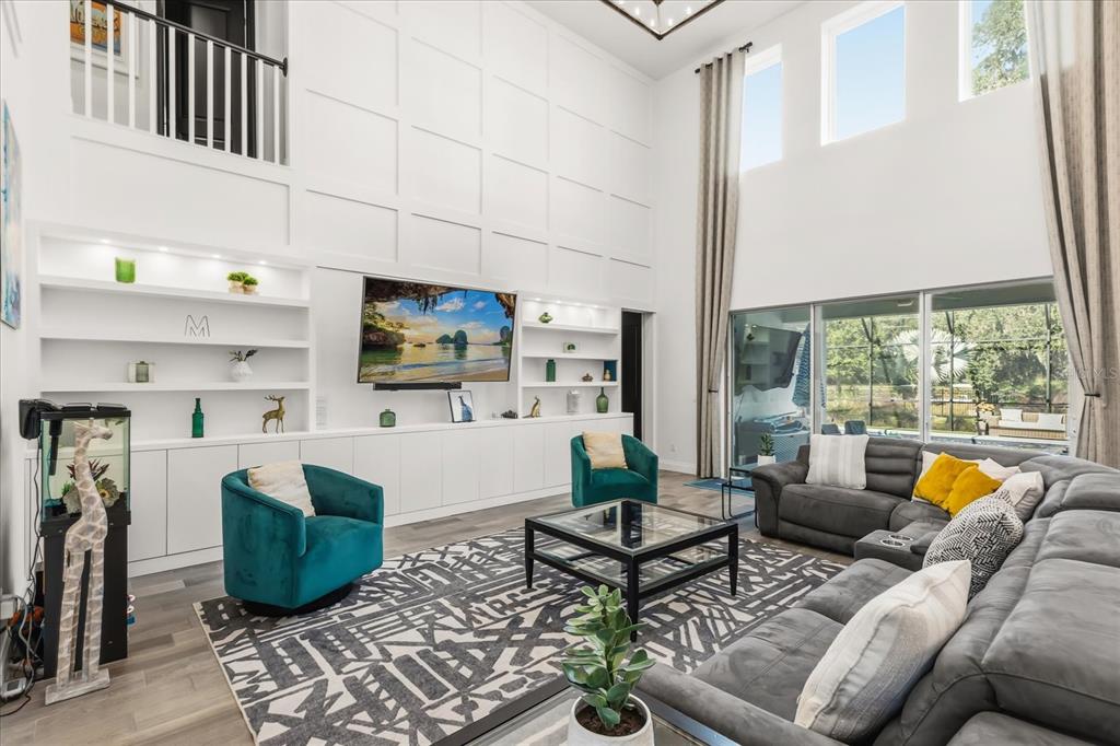 639 Primrose Willow Way Apopka, FL 32712 - Photo 12 of 70 a living room with furniture a rug and a floor to ceiling window