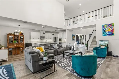 a living room with furniture and kitchen view