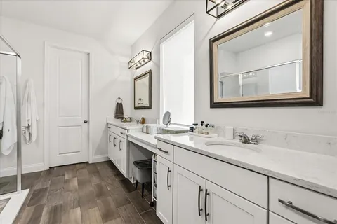 a view of a hallway with wooden floor and stairs