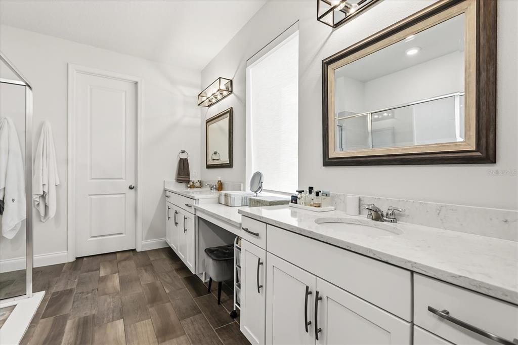 639 Primrose Willow Way Apopka, FL 32712 - Photo 25 of 70 a bathroom with a double vanity sink and mirror