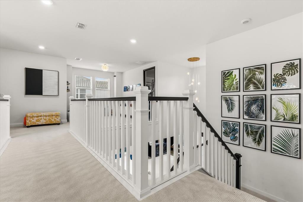 639 Primrose Willow Way Apopka, FL 32712 - Photo 29 of 70 a view of a hallway with wooden floor and stairs