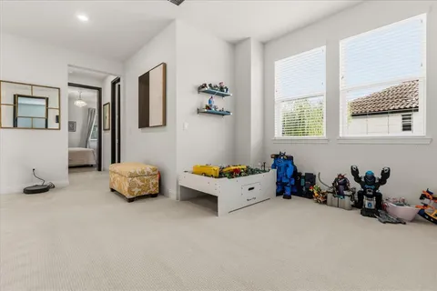 a bedroom with a bed flat screen tv and window