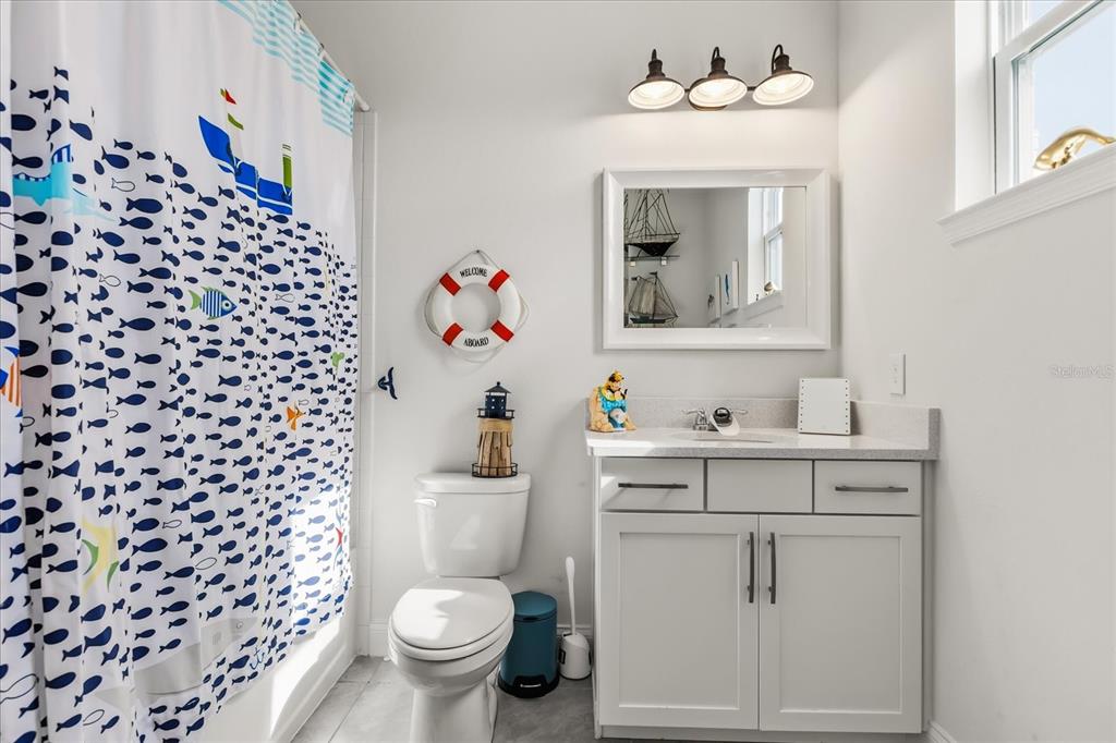 639 Primrose Willow Way Apopka, FL 32712 - Photo 36 of 70 a bathroom with a sink vanity mirror and toilet