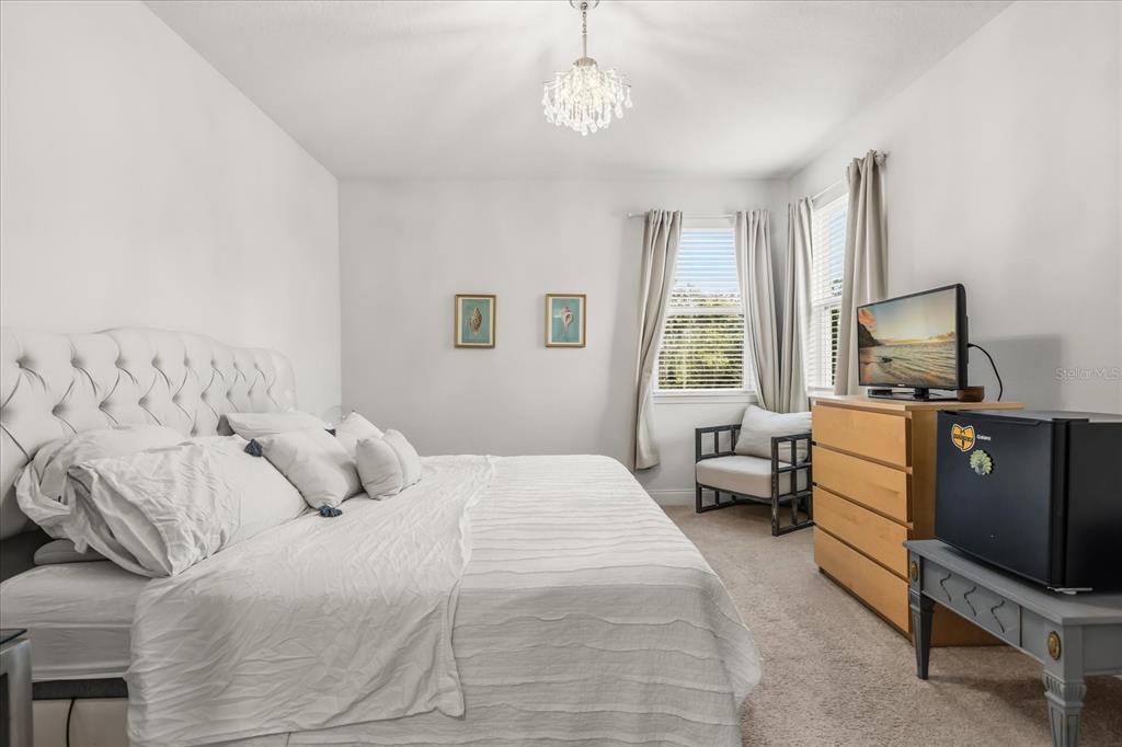 639 Primrose Willow Way Apopka, FL 32712 - Photo 39 of 70 a bedroom with a bed flat screen tv and window