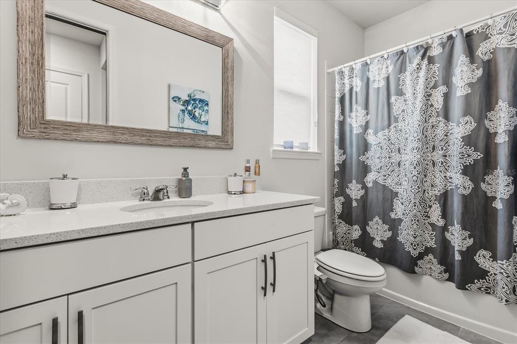 639 Primrose Willow Way Apopka, FL 32712 - Photo 41 of 70 a bathroom with a granite countertop toilet sink and mirror