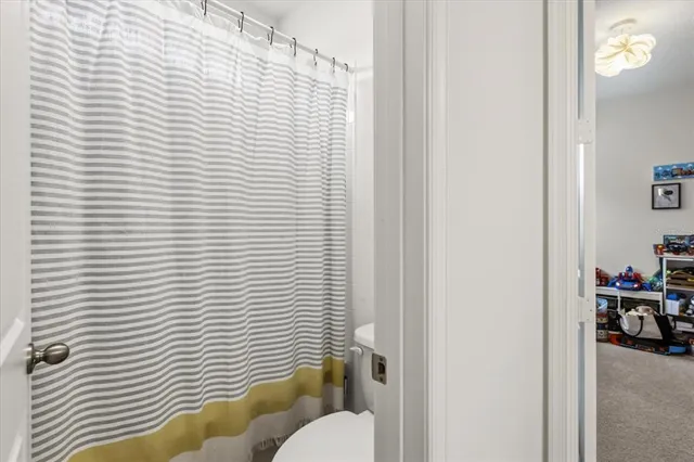 a view of a house with a small yard and a large tree