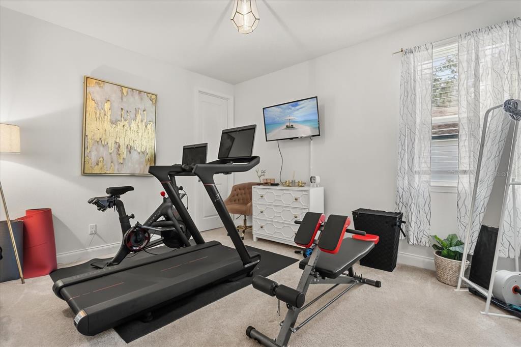639 Primrose Willow Way Apopka, FL 32712 - Photo 46 of 70 a room with gym equipment and windows
