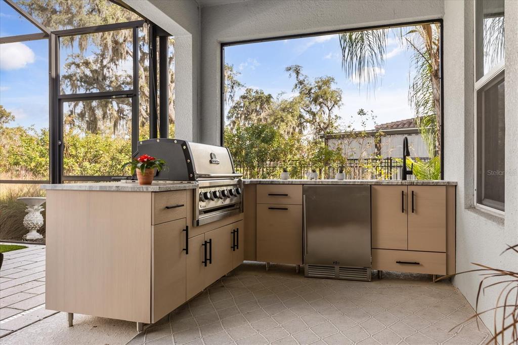 639 Primrose Willow Way Apopka, FL 32712 - Photo 48 of 70 a kitchen with stainless steel appliances granite countertop a stove and a large window