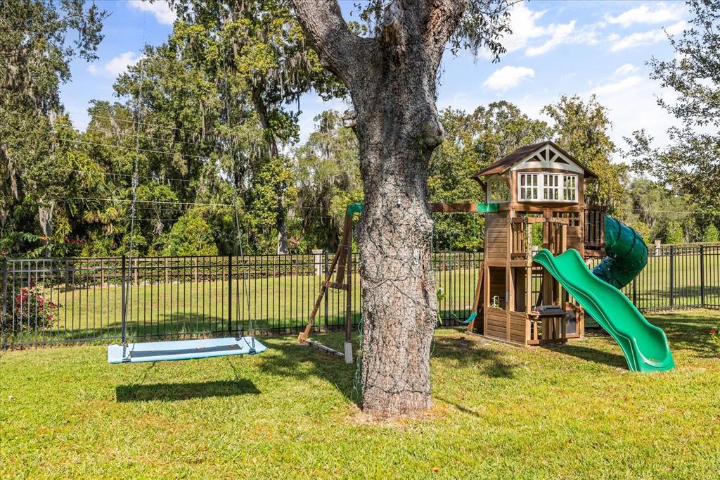 639 Primrose Willow Way Apopka, FL 32712 - Photo 59 of 70 a view of a house with a small yard and a large tree