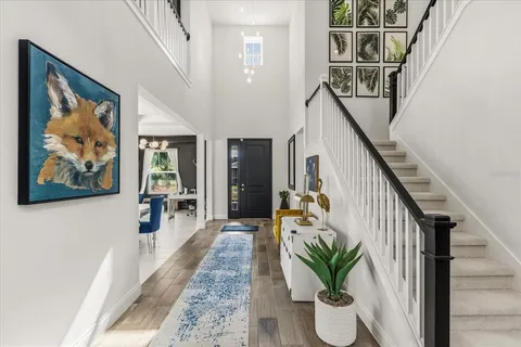 a view of entryway and hall with wooden floor