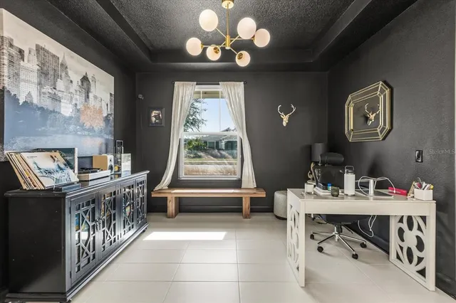 a dining room with wooden floor and a chandelier