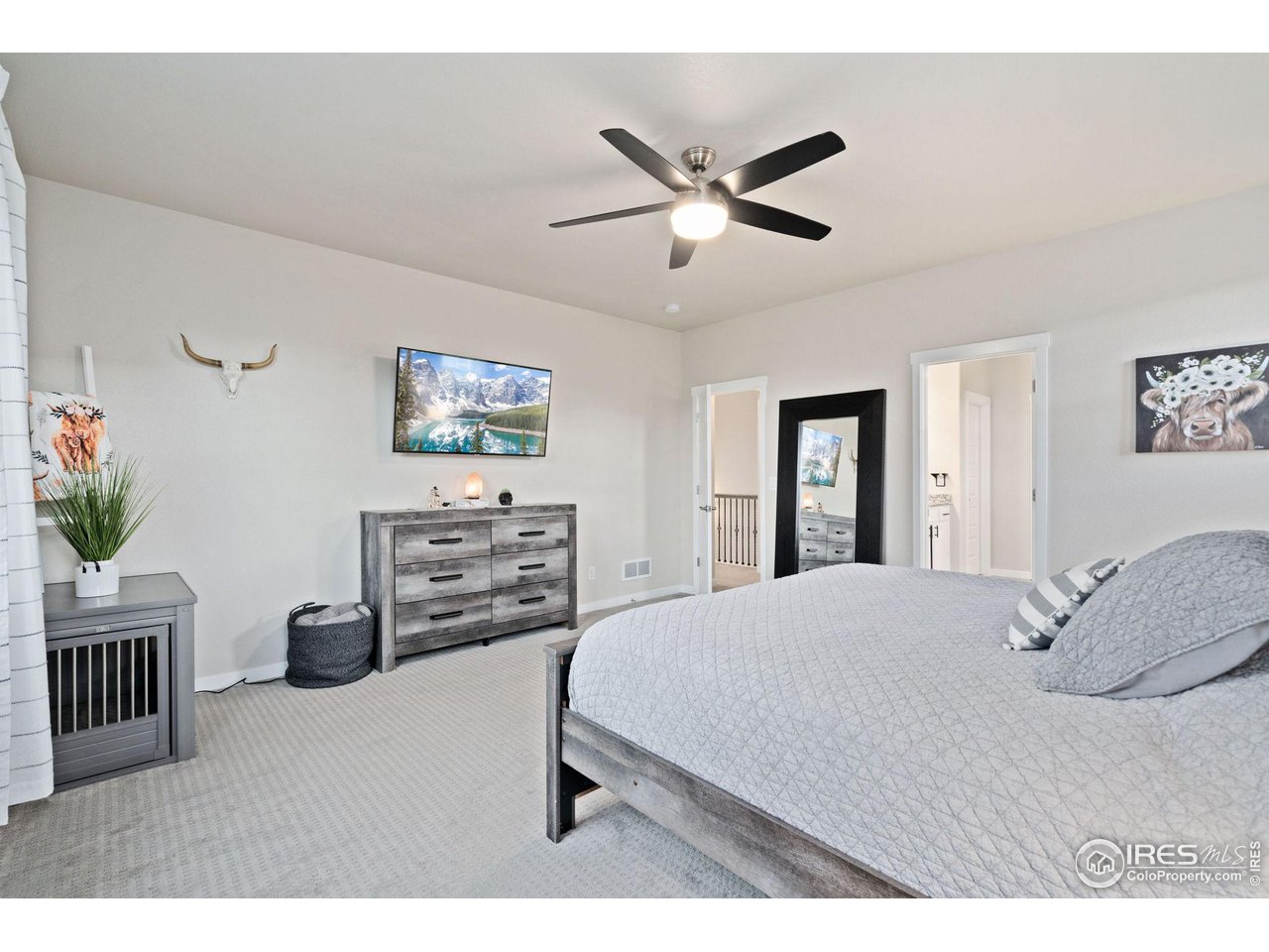 2167 First Light Court Windsor, CO 80550 - Photo 15 of 40 a bedroom with a bed a couch and potted plant