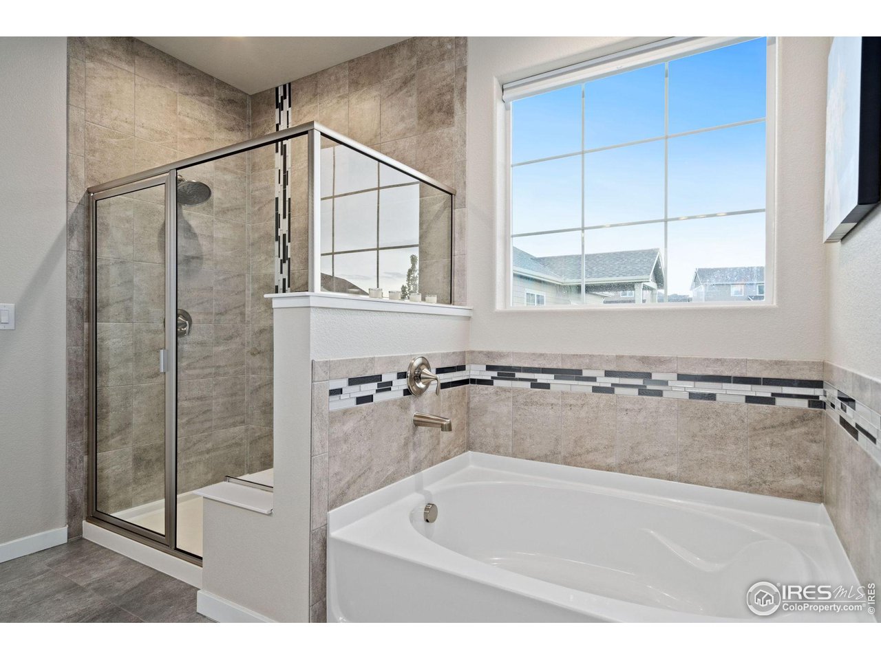 2167 First Light Court Windsor, CO 80550 - Photo 17 of 40 a bathroom with a bath tub and a shower