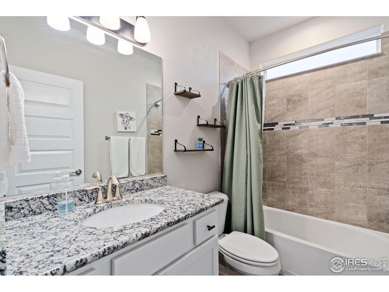 2167 First Light Court Windsor, CO 80550 - Photo 19 of 40 a bathroom with a granite countertop sink toilet and shower