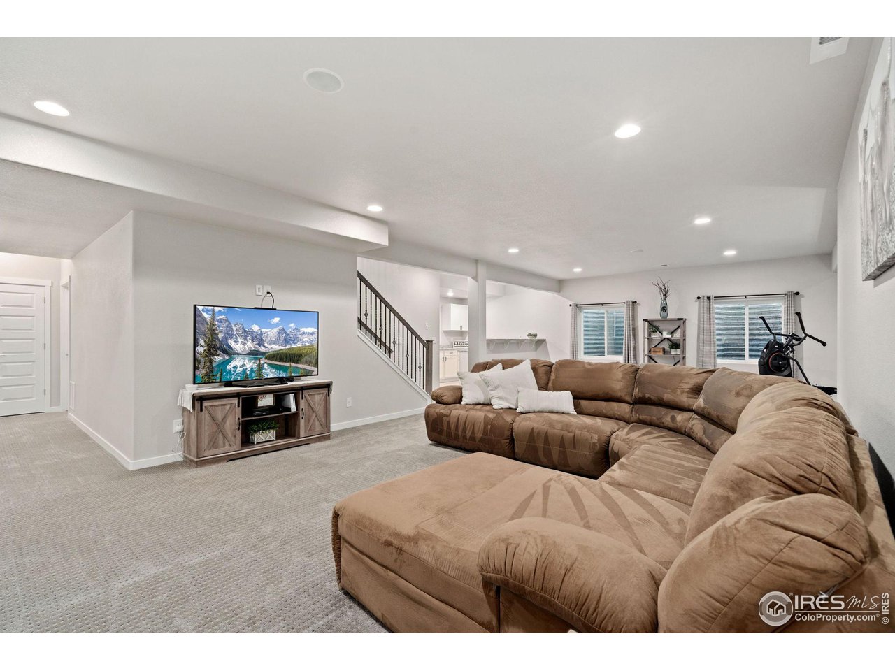 2167 First Light Court Windsor, CO 80550 - Photo 24 of 40 a living room with furniture and a flat screen tv