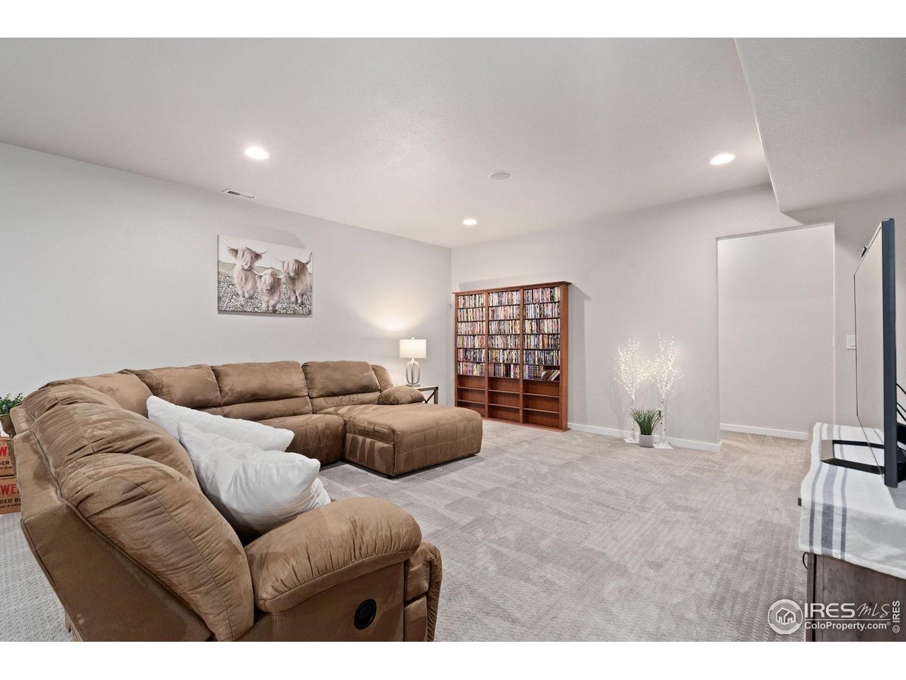 2167 First Light Court Windsor, CO 80550 - Photo 25 of 40 a living room with furniture window and a lamp