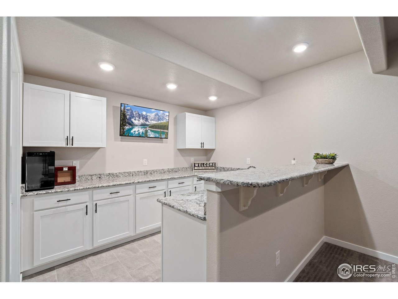 2167 First Light Court Windsor, CO 80550 - Photo 27 of 40 a kitchen with granite countertop a sink and cabinets