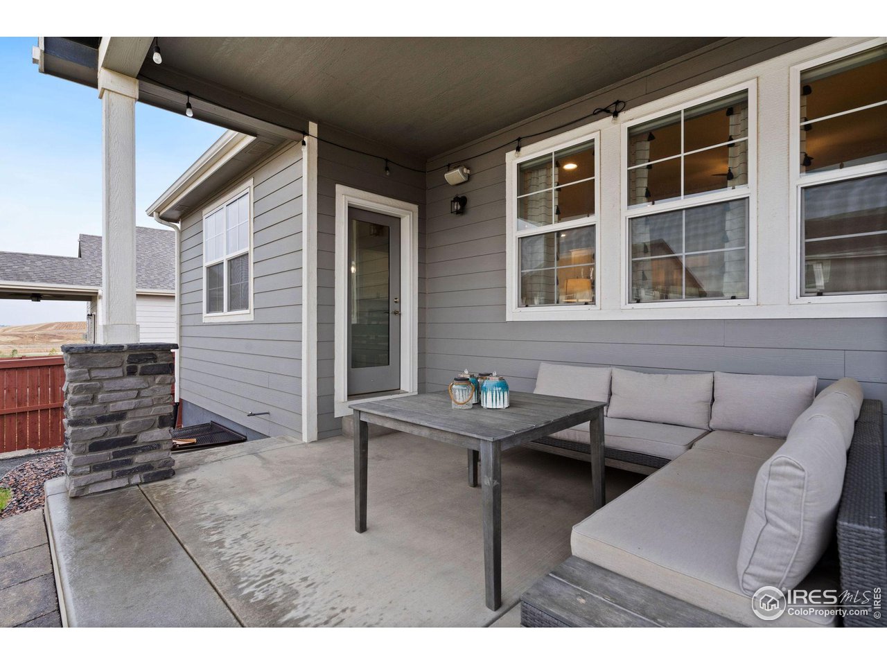 2167 First Light Court Windsor, CO 80550 - Photo 34 of 40 a backyard of a house with barbeque oven table and chairs