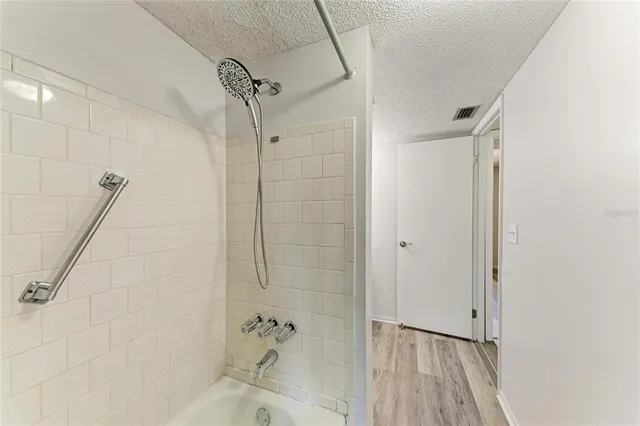 a bathroom with a bathtub and a shower