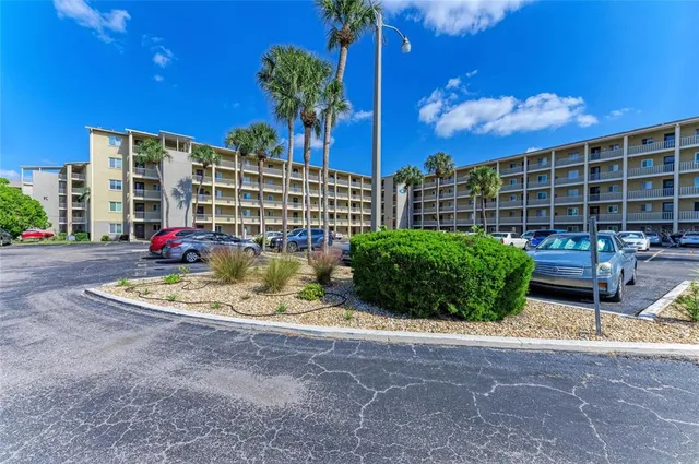 a view of pool with lawn chairs and a yard