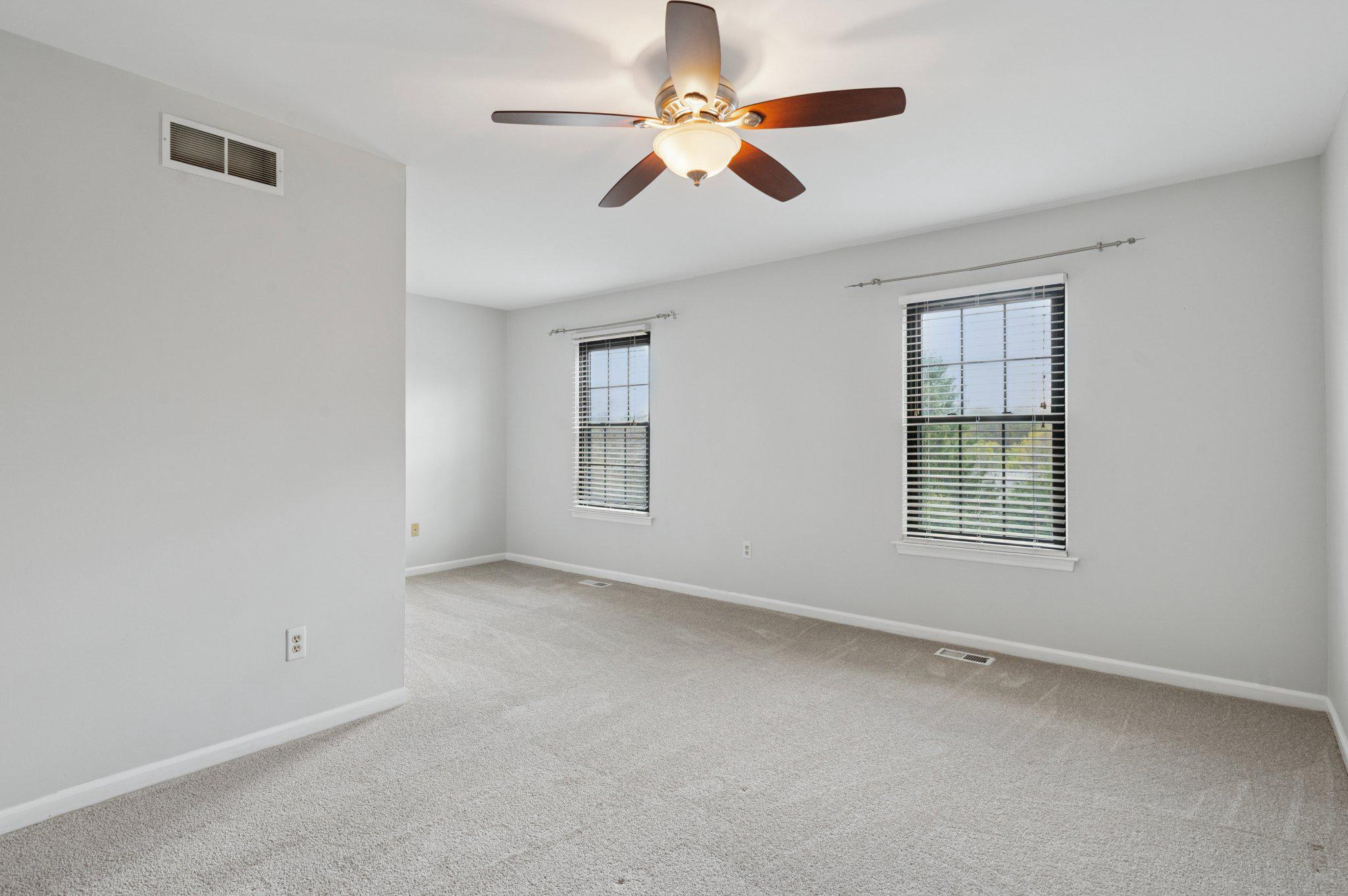 237 McIntosh Road, Unit 82 West Chester, PA 19382 - Photo 9 of 18 an empty room with windows and fan