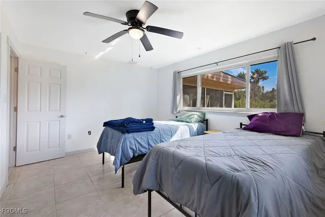 a bedroom with two beds and a large mirror
