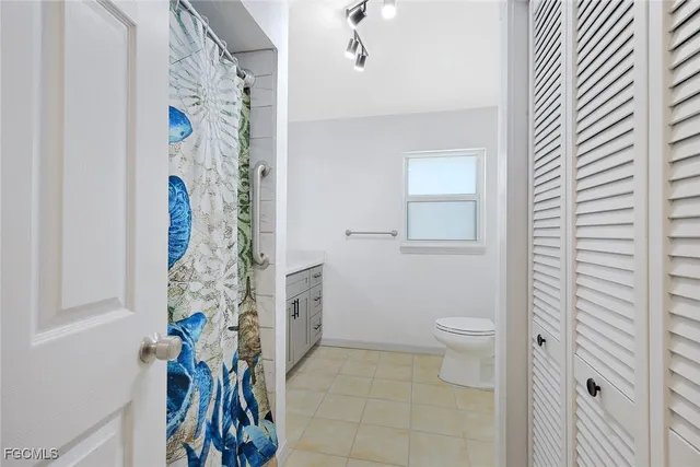 a bathroom with a toilet and a shower curtain