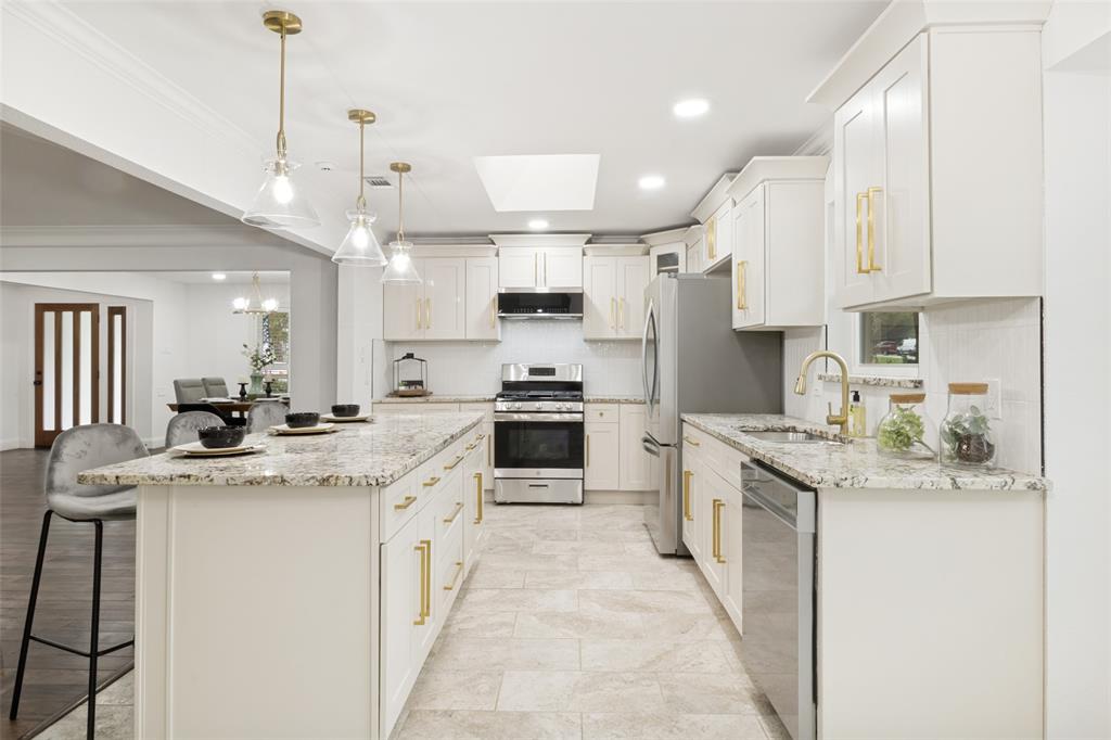 9552 Timberleaf Drive Dallas, TX 75243 - Photo 12 of 32 a kitchen with stainless steel appliances granite countertop a sink and cabinets